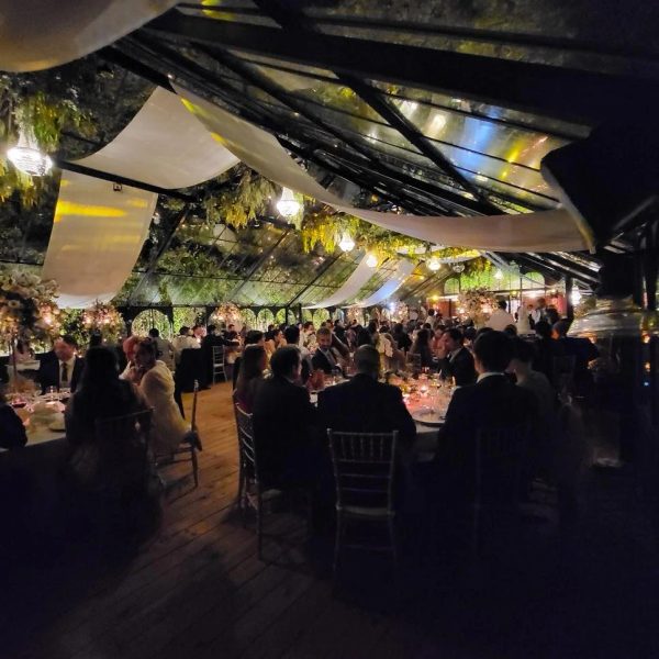 Daytime celebration in the Victorian greenhouse at Quinta da Bella Vista with draped long tables